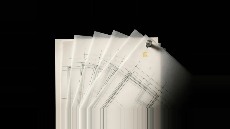 Fanned translucent drawing overlays on a pale floor plan, wall lines slightly out of register, one yellow alignment mark.