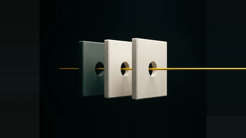 Three pale concrete plates standing on edge in darkness, their drilled holes aligned by a single slim yellow rod.