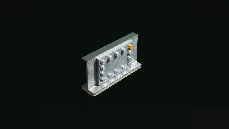 Close-up of a bolted steel beam splice plate in darkness, one bolt anodised bright yellow among pale steel bolts.