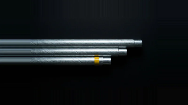 Overhead view of three galvanised conduit lengths, flush at one end and unequal at the other, one marked yellow.