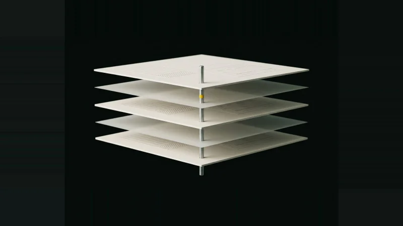 Exploded stack of blank pale document sheets on a metal alignment pin, one sheet rotated off-register, on black