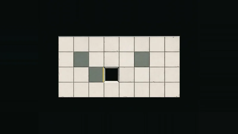 Overhead view of a small grid of pale concrete tiles on black, one tile missing, its cut edge lined in yellow.