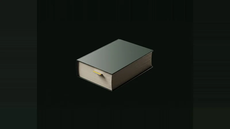A thick specification book lit only at its edges, one metal index tab with a yellow band, alone in blackness.