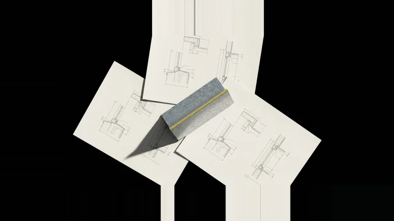 Overhead view of three overlapping architectural detail sheets with a folded galvanised flashing profile laid across their…