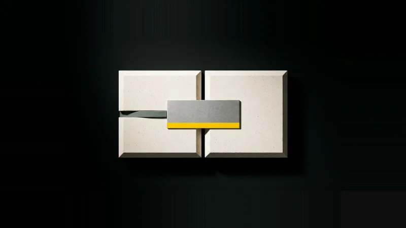 Overhead view of a machined metal shim bridging the hairline gap between two pale concrete tiles on black.