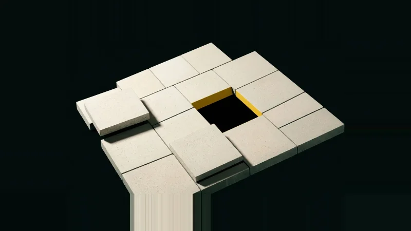 Overhead view of a grid of pale concrete tiles with one tile missing, leaving a black void edged in yellow.