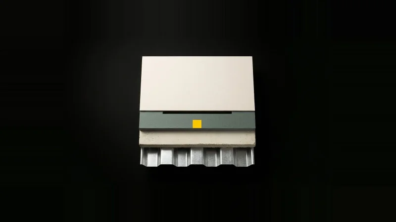 Overhead view of a stepped building envelope specimen — metal deck, concrete, insulation, board — with one layer missing.