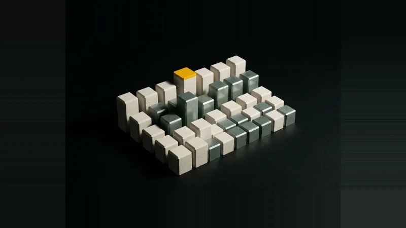 Grid of pale concrete blocks at varying heights on black, one column capped in yellow, long raking shadows