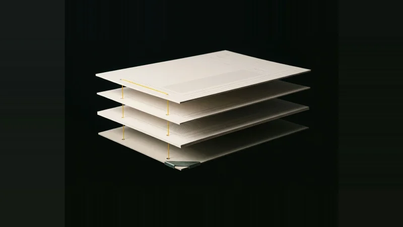 Four off-white sheets floating in exploded alignment, a single yellow thread stitched through their punched holes, on black